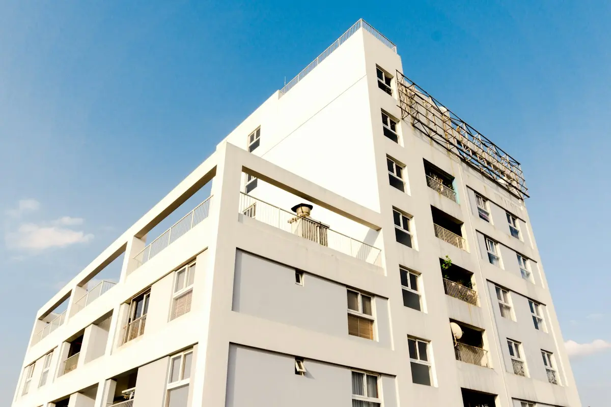Mid rise commercial building with a flat roof system under a clear South Florida sky